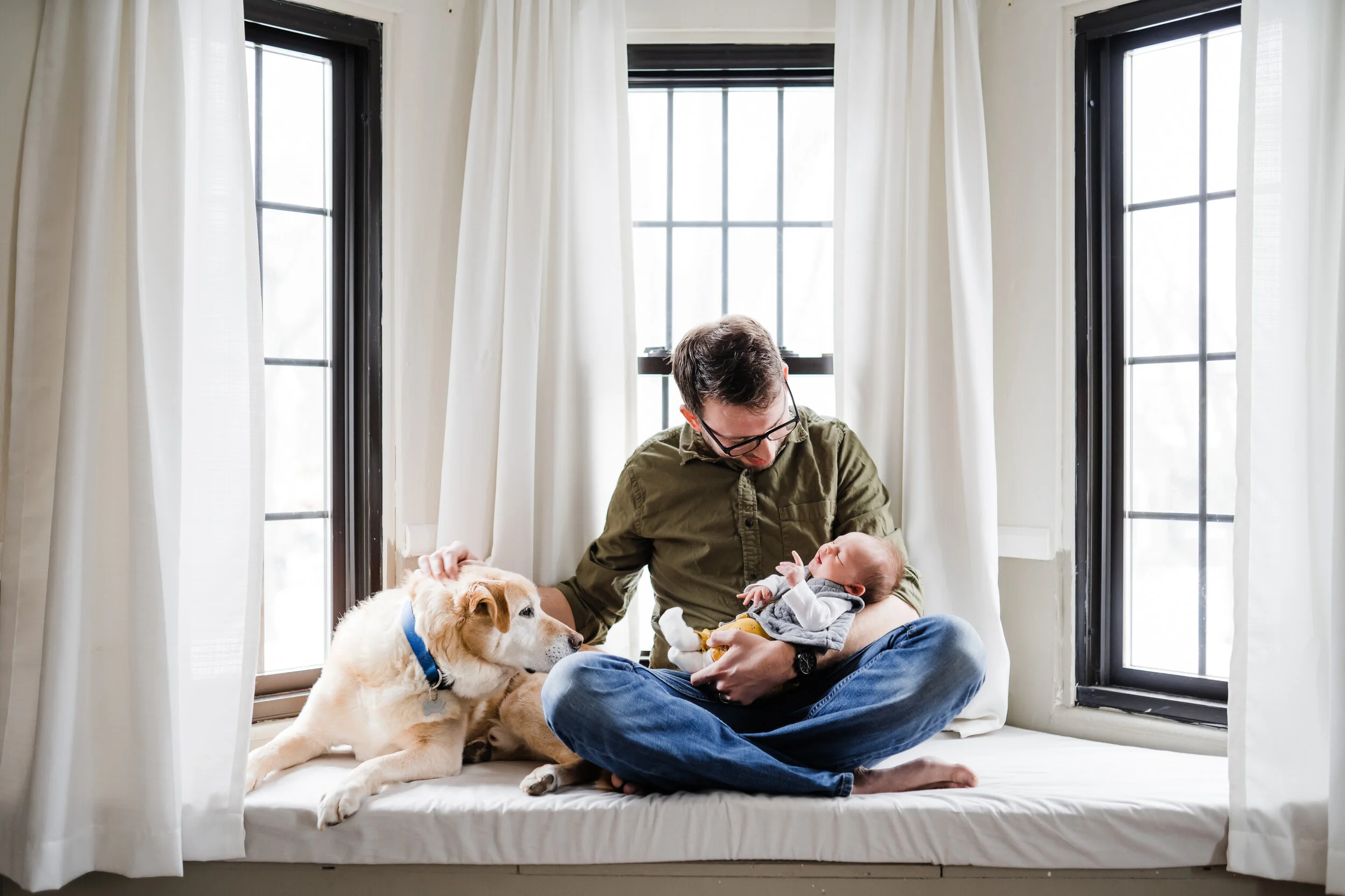  At home Newborn family photo session in Flint, Michigan by Pop Mod Photo photographers Ryan Garza and Courtney Simpson. 