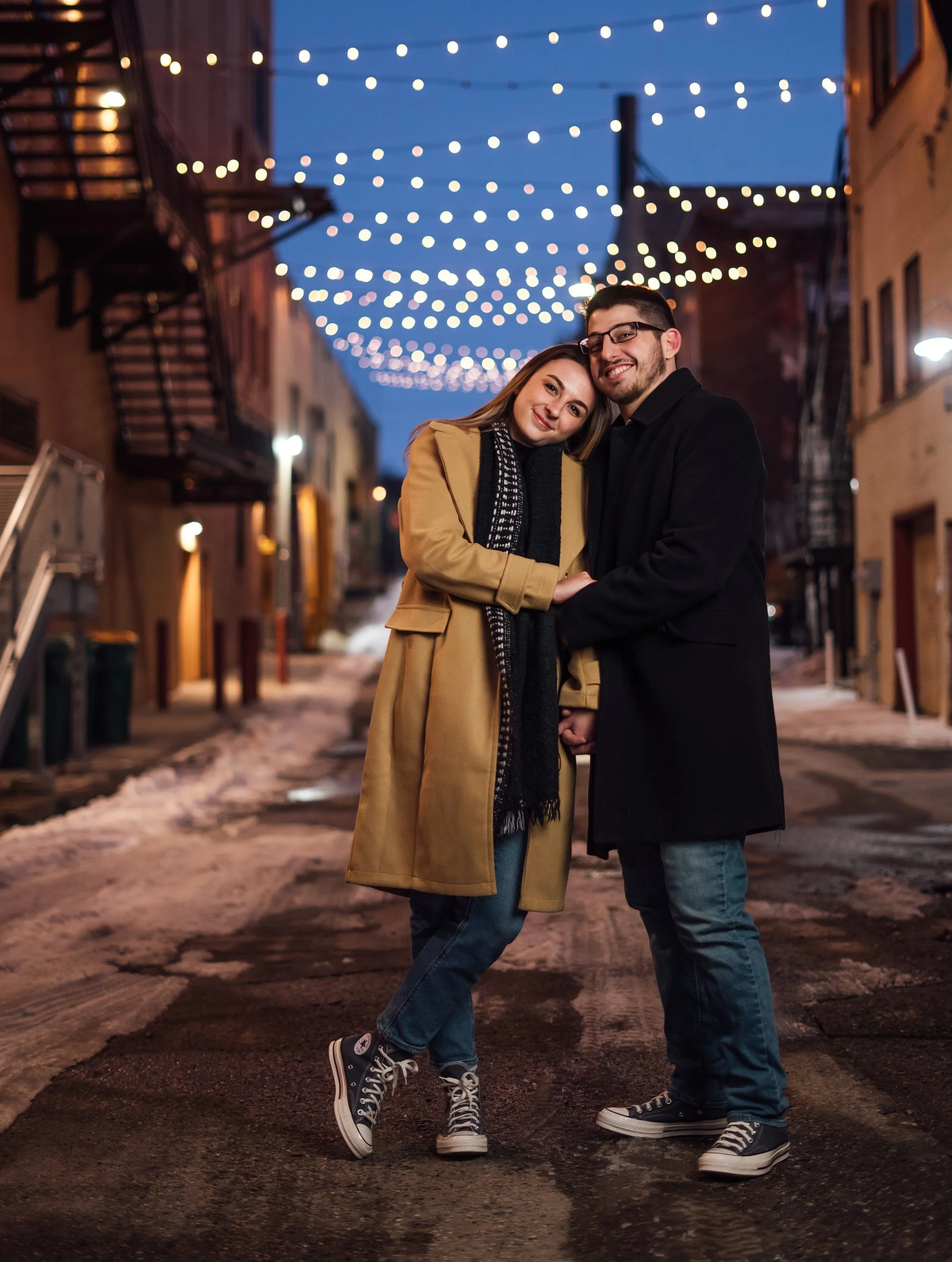  Anthony and Madison joined Pop Mod Photo wedding photographers Ryan Garza and Courtney Simpson for their Michigan winter downtown urban engagement photo session in downtown Flint, Michigan in time for a snowy sunset. 