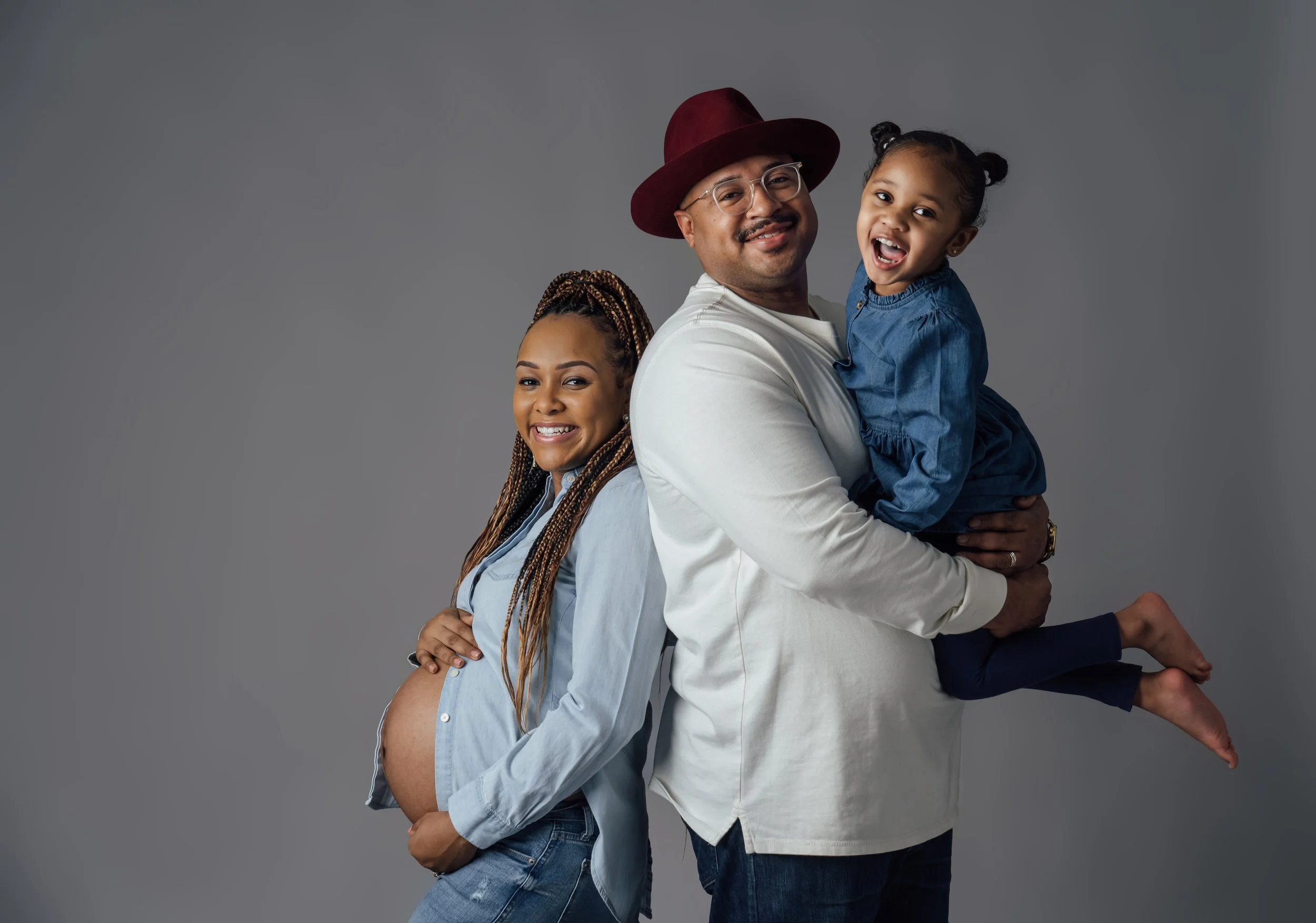  Ciera and Joscquece celebrated the upcoming birth of their new child during their in-studio family and maternity photo session at Pop Mod Photo in downtown Flint, Michigan by Pop Mod Photo photographers Ryan Garza and Courtney Simpson in Flint, Mich