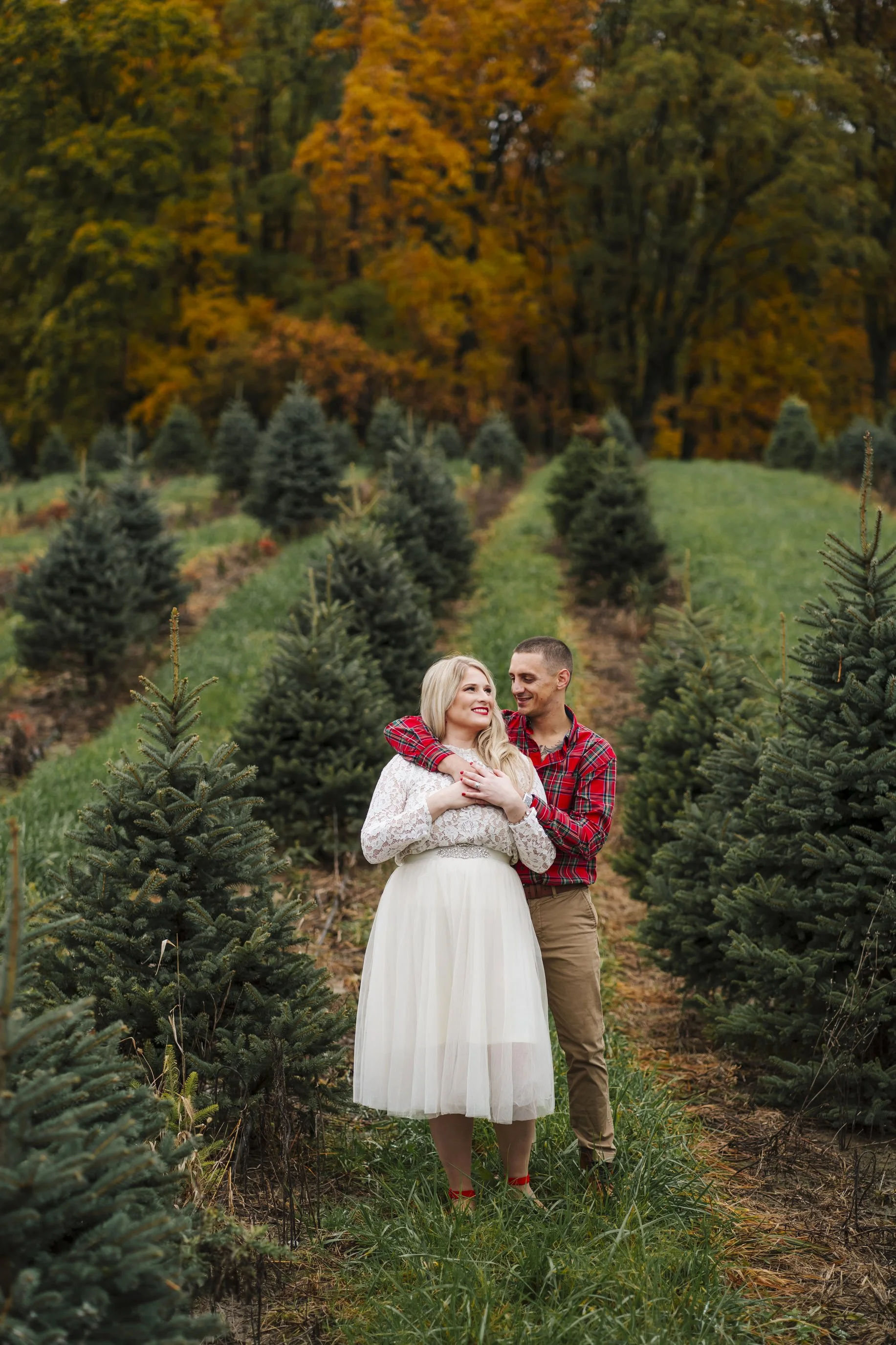  Melissa and Michael went to Top Hill Farms christmas tree farm in Goodrich, Michigan for a fall holiday themed engagement photo session with Pop Mod Photo wedding photographers Ryan Garza and Courtney Simpson before heading to downtown Flint, Michig
