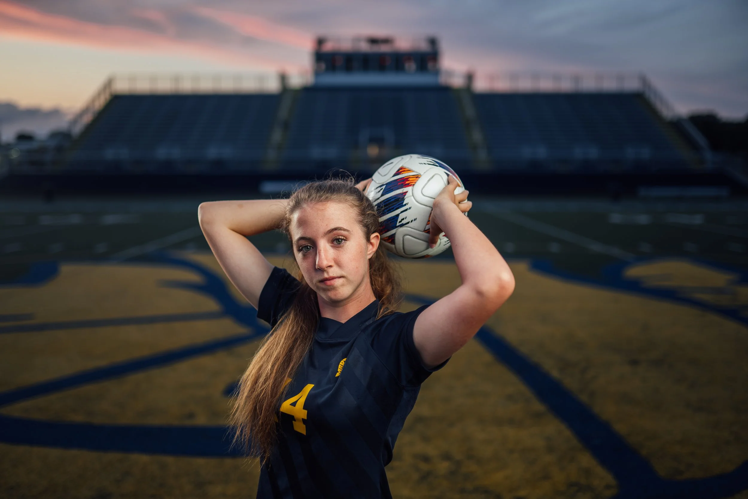  Goodrich High School senior Izzy did her senior soccer sunset photoshoot at Goodrich High School in Goodrich, Michigan with Pop Mod Photo high school senior photographers Ryan Garza and Courtney Simpson. The portrait session included her prom dress 