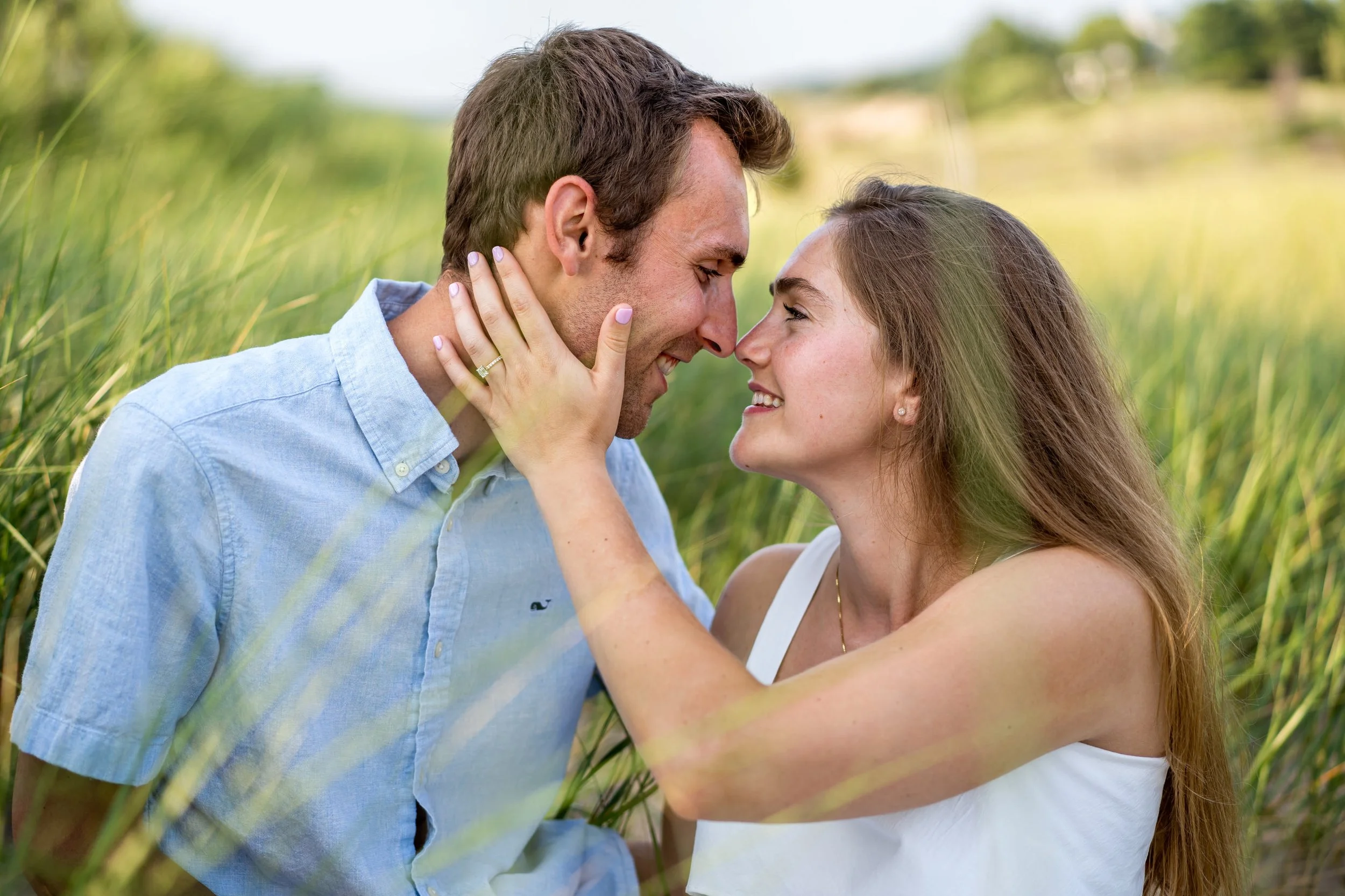  Alex and Brennen celebrated their sunset summer wedding engagement session at Oval Beach in Saugatuck, Michigan as they walked along Lake Michigan and embraced on the sand dunes with Pop Mod Photo wedding photographers Ryan Garza and Courtney Simpso