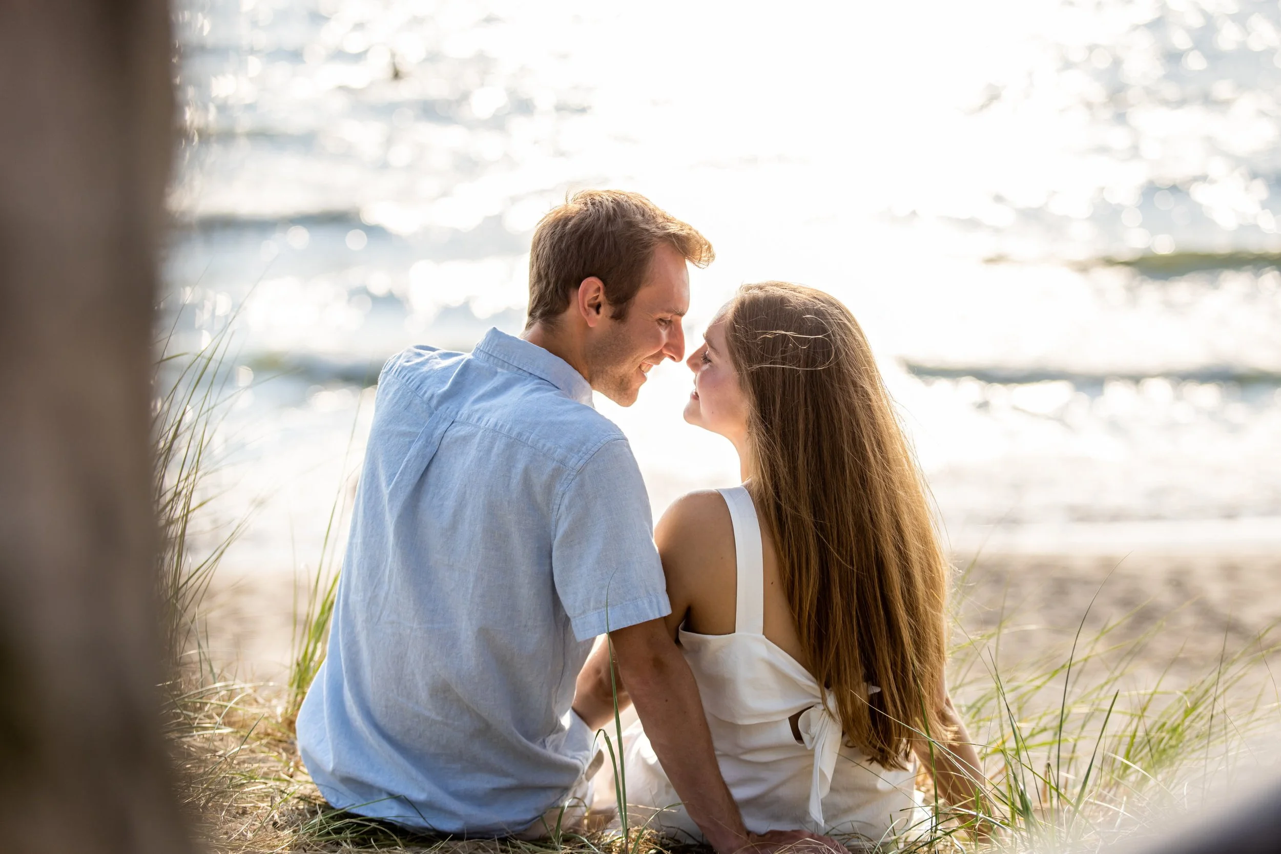  Alex and Brennen celebrated their sunset summer wedding engagement session at Oval Beach in Saugatuck, Michigan as they walked along Lake Michigan and embraced on the sand dunes with Pop Mod Photo wedding photographers Ryan Garza and Courtney Simpso