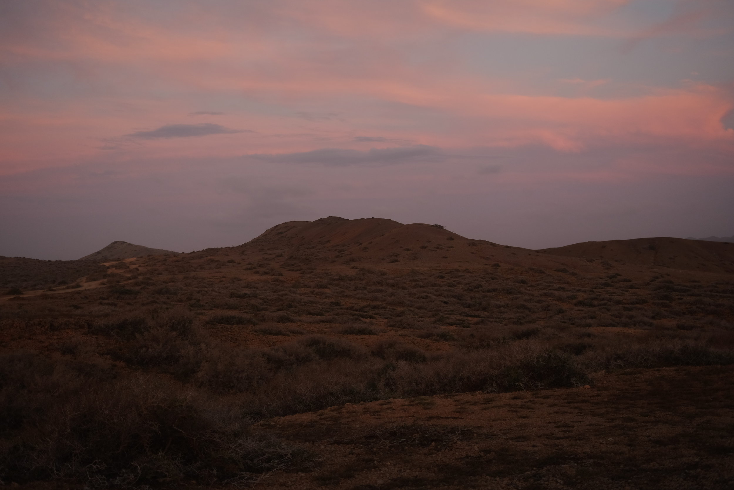 Pink skies and desert plains.