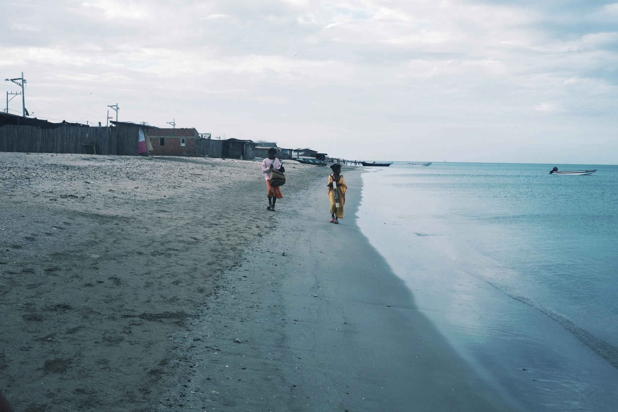 Girls walking along the beach.