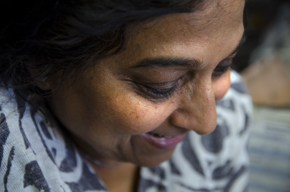  Jyoti Patel grins as she entertains herself with her mobile while her corner shop, Pedlar's News in Edgware, UK,&nbsp;is empty. 