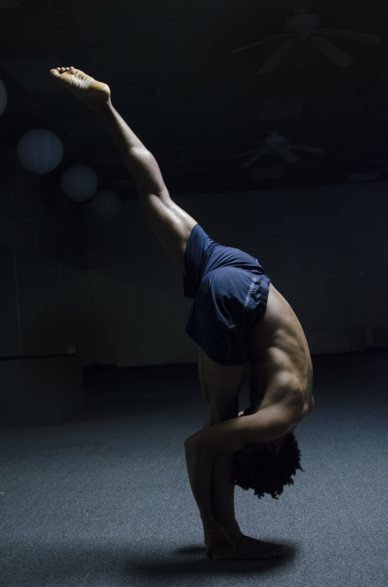 After teaching two hot yoga classes in one day, Joel Lindo performs advanced level poses in the studio. 