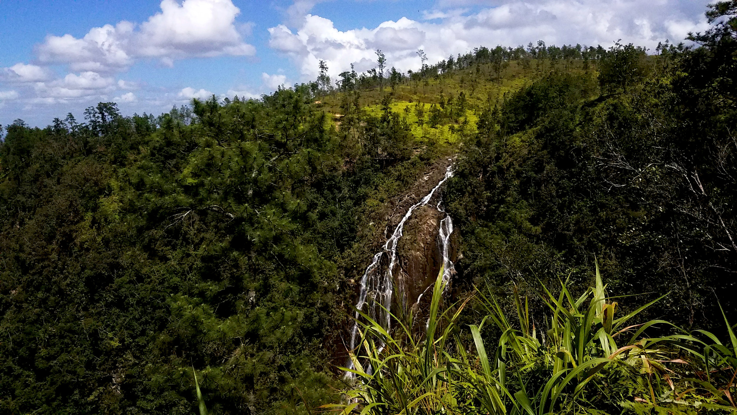 Tiger Creek Falls, as seen from one of many private lookouts, crash down the Mountain Pine Ridge of Belize.