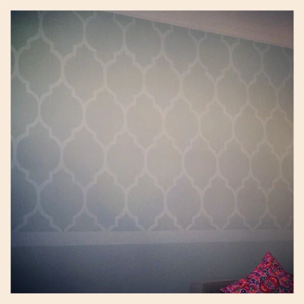 I recently repainted my walls, and although I really liked having some color, I felt there was something more I could do, and I remember seeing this really cool technique of painting a wallpaper pattern:
http://jonesdesigncompany.com/decorate/painted-wallpaper-a-tutorial/ (you can download a template to use here)
http://littlenannygoat.blogspot.com/2010/09/painted-wallpaper.html
It looked extremely challenging, and I’m always looking for a shortcut and an easy way out, and I think I found some (I’d rather spend more time thinking of ways to make the whole process easier than to actually just doing it the way I’m supposed to).
I had a lot of leftover paint from my wall, so I bought some white paint to mix with the color to create a tonal pattern.
First shortcut: I made the template shape bigger to have a fewer amount of total shapes to trace/paint. I modified their shape slightly in Illustrator (made it fatter and rounder), printed it out, traced it onto a sturdy shopping bag, and cut it out to use as a template/stencil. It’s about 11" wide.
I traced this over and over again in pencil onto my wall, and it took HOURS. I messed up once, and erased it…shouldn’t have done that because it created a really big smudge on the wall. Luckily after it was painted it got covered up. I tried to leave about ¾" space between each shape, and planned on filling those spaces with the paint.
I taped little ¾" tabs to the template to use as spacers. I didn’t really make any other measurements on the wall, just eyeballed it.
Penciled outlines.
Second shortcut: the examples on those sites paint INSIDE the traced shape, meaning they get double lines, and essentially have to paint every outline of every shape. I decided to paint OUTSIDE the traced shape (the negative space, per se) so the merged area is what I ended up painting (less shapes to paint).
Me: painting outside of the lines.
Them: painting inside the lines, resulting in two strokes.
Third shortcut: because I am doing a wall that my couch is in front of, I didn’t feel like I needed to do this pattern from floor to ceiling. I did about 2/3 of the wall, and left the bottom 1/3 solid since it was going to be covered by the couch anyway, and there’s a radiator in the way.
Taped off the wall. The horizontal tape is where I’m stopping the pattern, about 1/3 from the floor.
Full wall done. Almost complete with the project…I didn’t want the pattern to end awkwardly and abruptly at the bottom like that, so I added a stripe.
More tape, making about a 3" wide stripe.
Finished.
This took a full weekend to do…the second day was a lot easier than the first because I realized it doesn’t have to be perfect. It looks fine from faraway, even if things are uneven or a little messy up close. I didn’t even bother erasing the pencil marks. It adds charm (lazy).