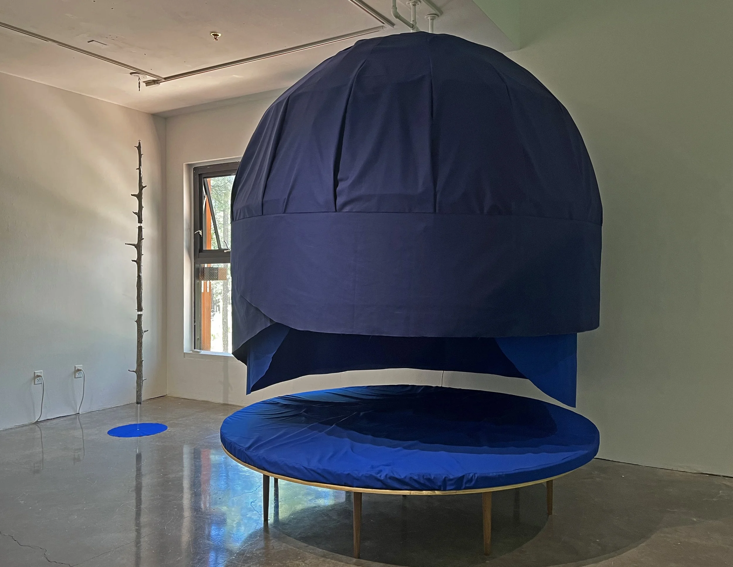 Sasha Petrenko, Sound Dome Moon Couch with Ghost Tree, 2025. Wood, fabric, foam, cardboard, aluminum, acrylic, sound. 9 x 8 feet.
