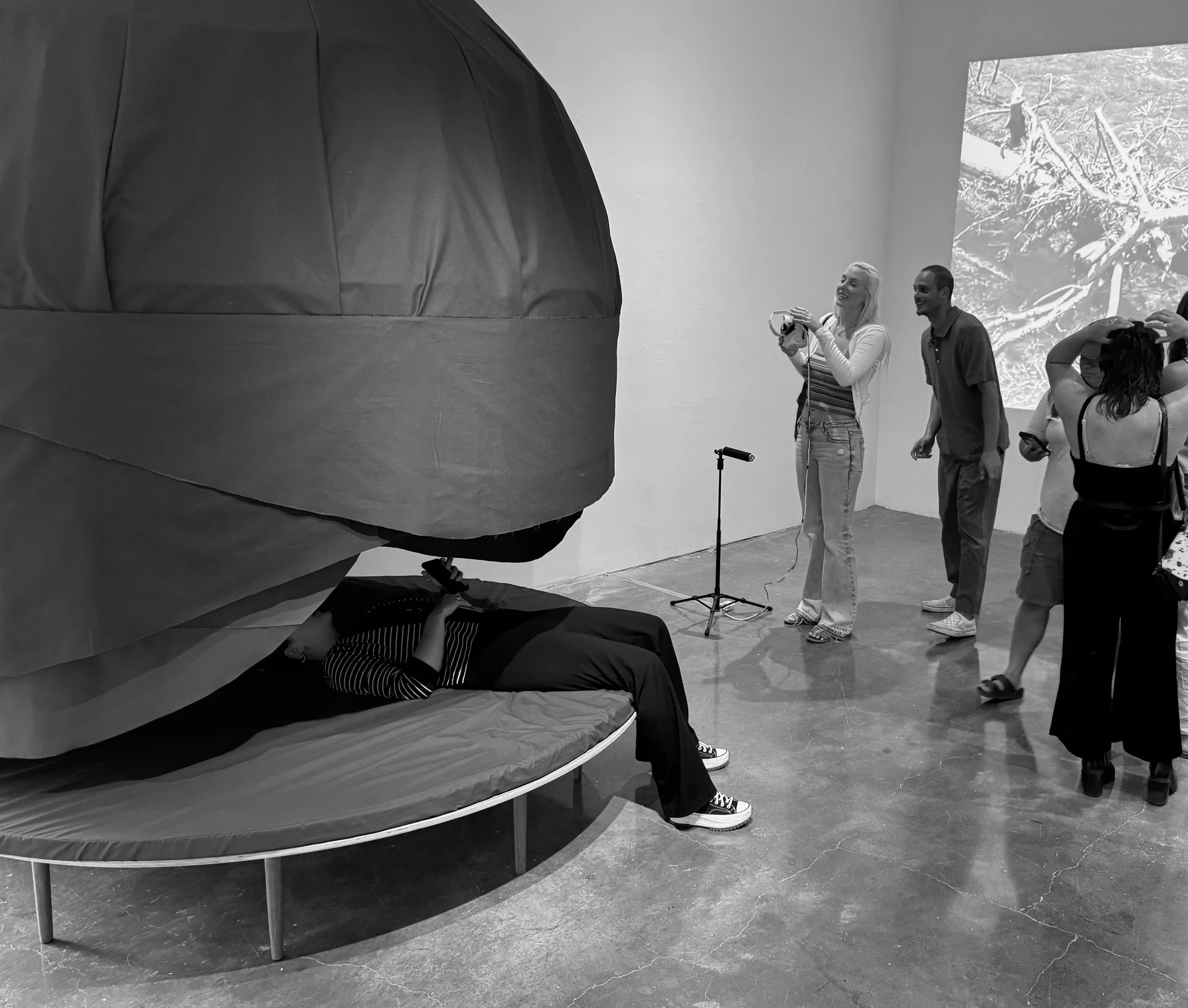 Sasha Petrenko, Sound Dome Moon Couch, 2025. Wood, fabric, foam, cardboard, aluminum, acrylic, sound. 9 x 8 x 8 feet.
