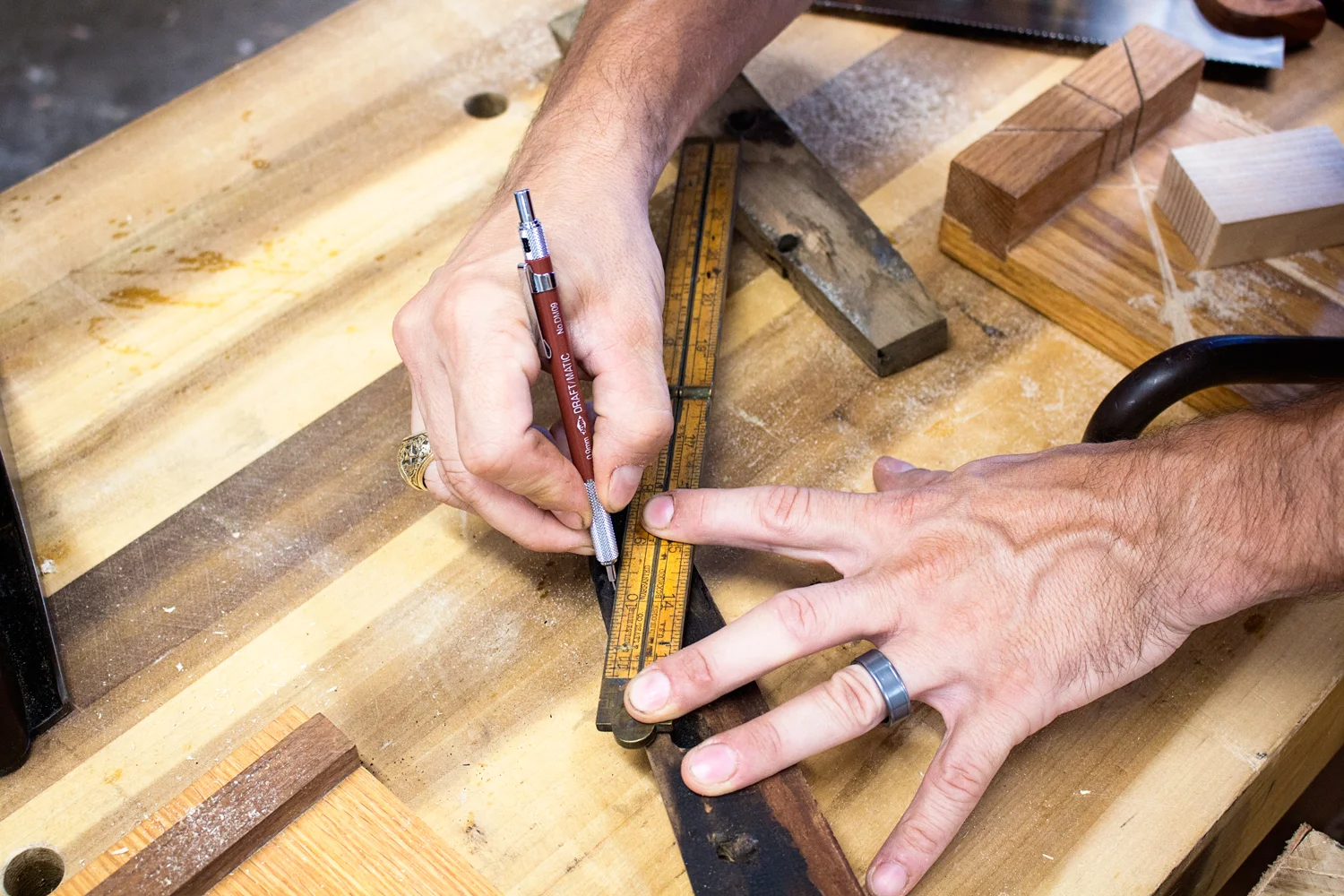 Marking the cut line using my Stanley Rule & Level Co. Folding rule as a straightedge. I try to go about 1/8" past the burned spots on the wood. I don't want any charred wood along my glueline. It wouldn't have the structural integrity needed.