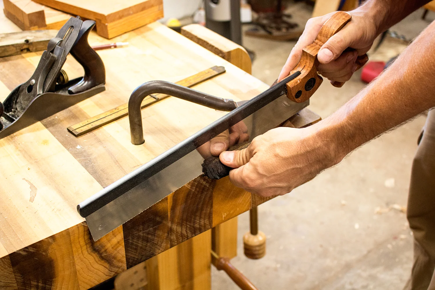 With the waste marked, I clamp the piece down to my benchtop with a holdfast, making sure that the cut line overhangs the benchtop. I use my Bad Axe Bayonet crosscut saw to remove the burnt section. 