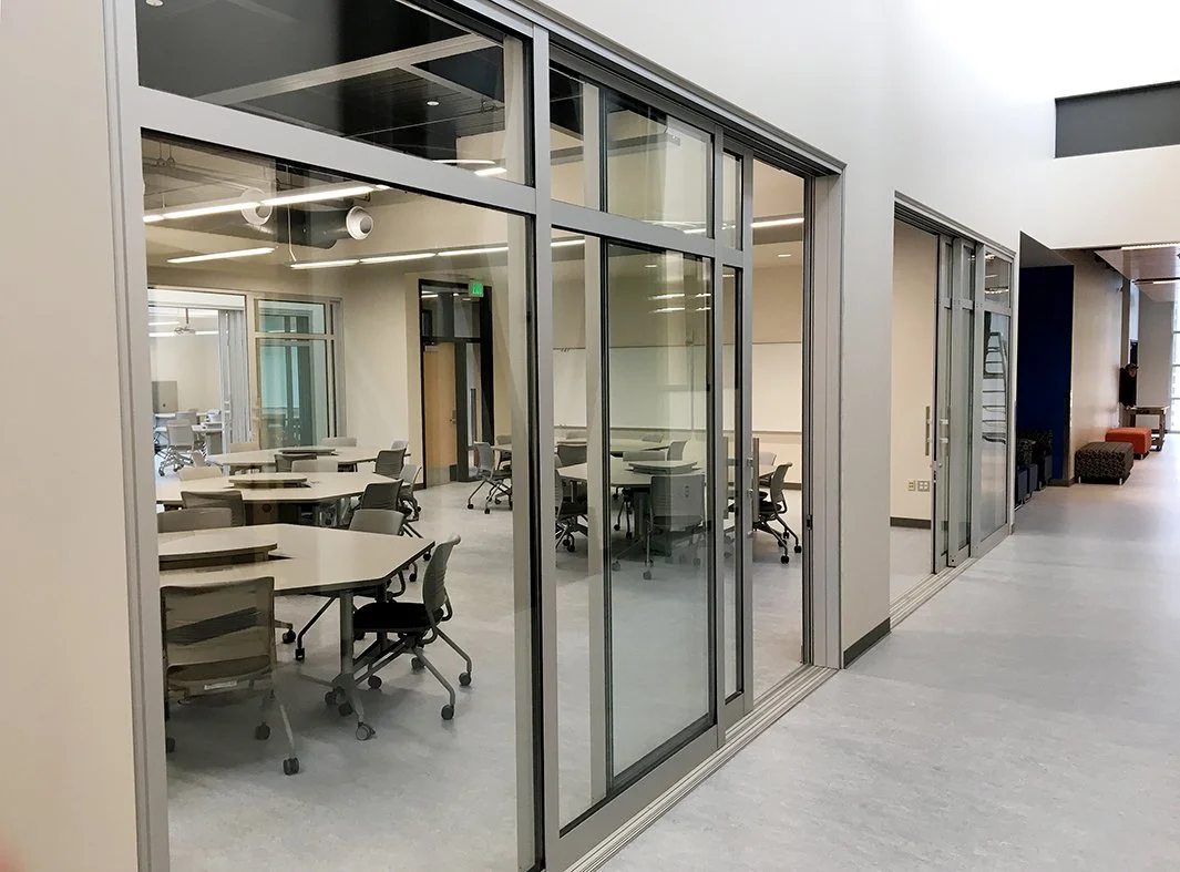 Slide & Stack Glass Wall panels dividing a collaborative classroom and learning commons