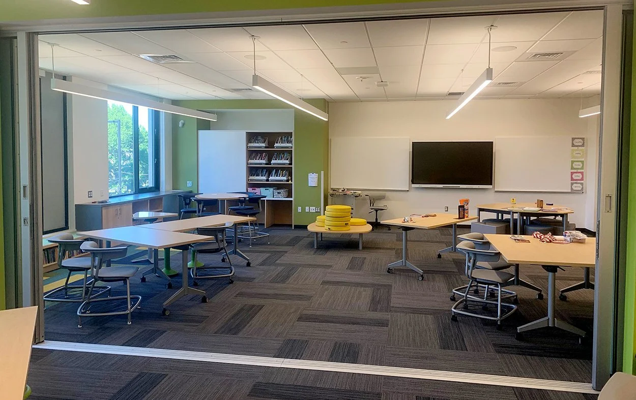 Solar Innovations Bi-Folding Door System opened between education classrooms