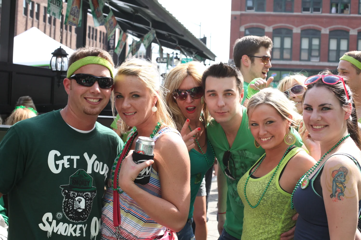 Friends celebrating together outside Annie’s Irish Pub in downtown Des Moines, Iowa, during a festive St. Patrick’s Day gathering
