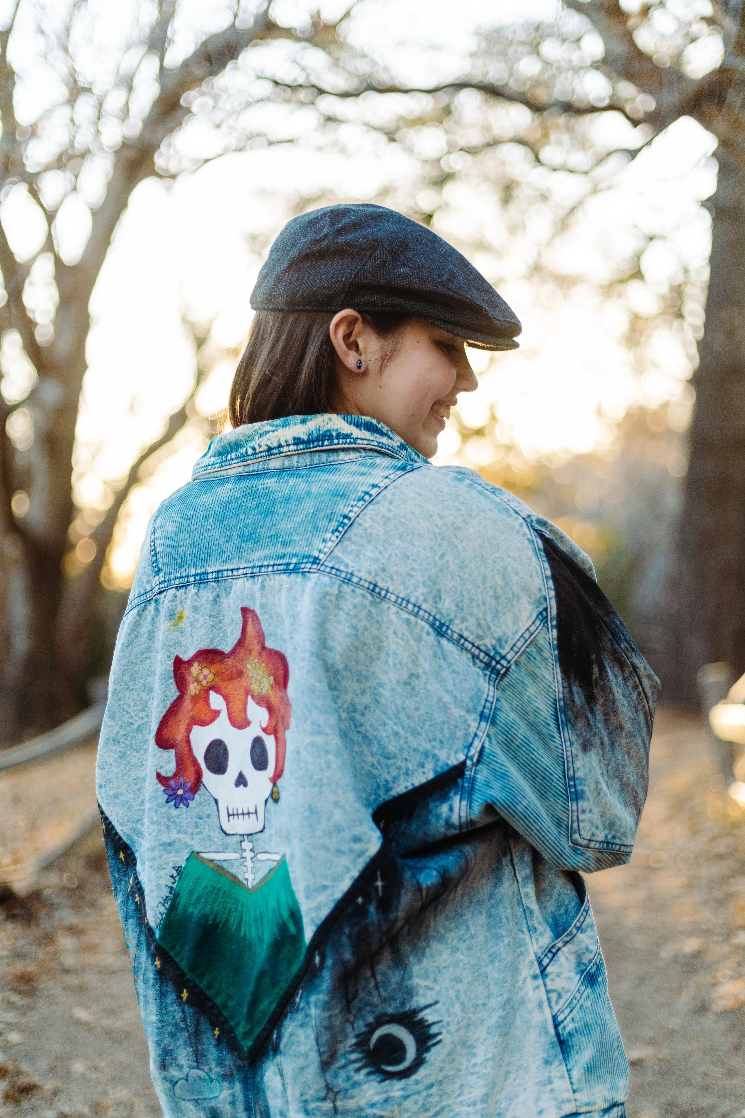 High school senior posing confidently and showcasing her artistic personal style during a creative graduation photoshoot.
