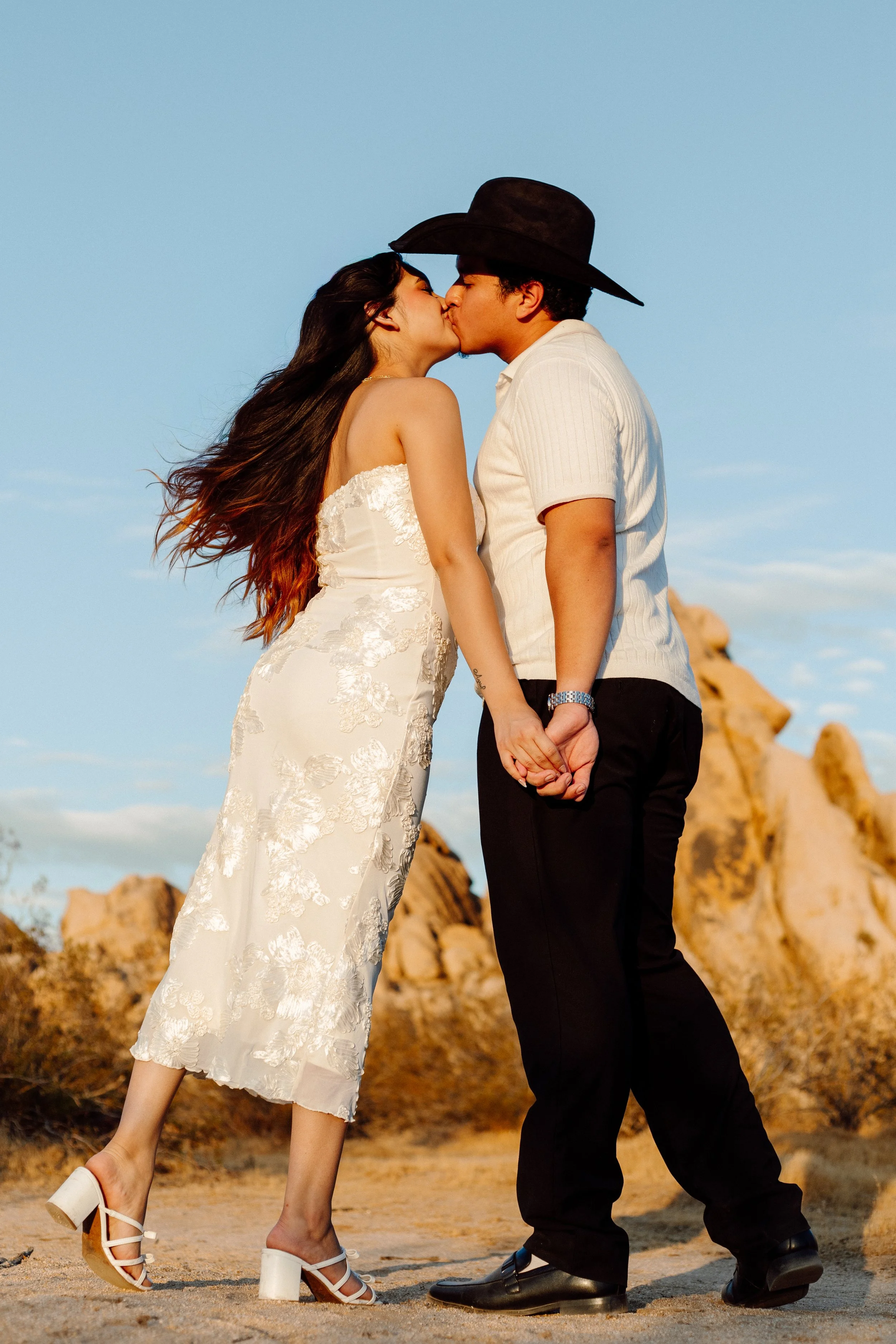 Engaged couple photoshoot in the desert next to a beautiful rock background in Apple Valley, CA