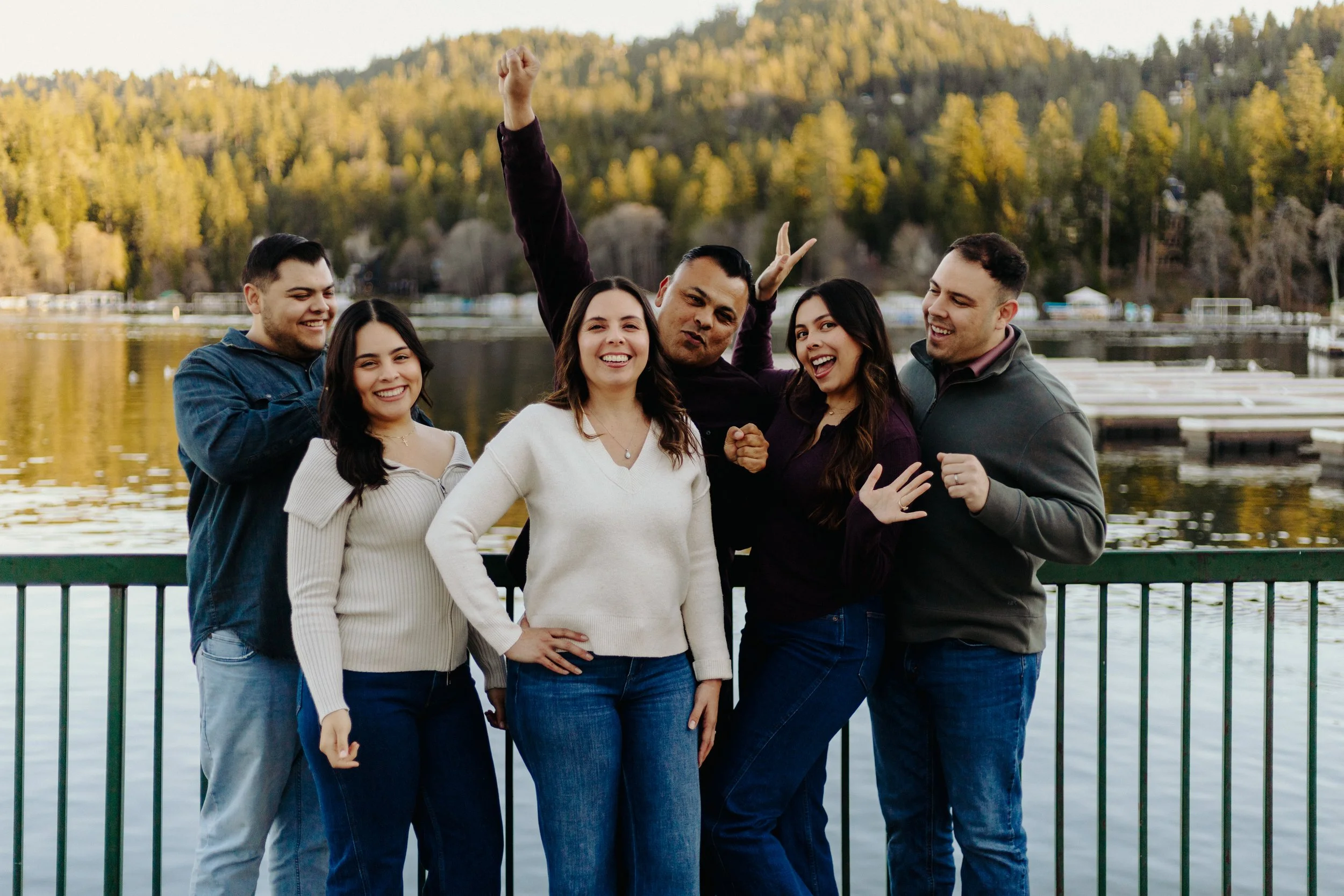 Family celebrating mother’s birthday together by a peaceful mountain lake surrounded by scenic alpine views.