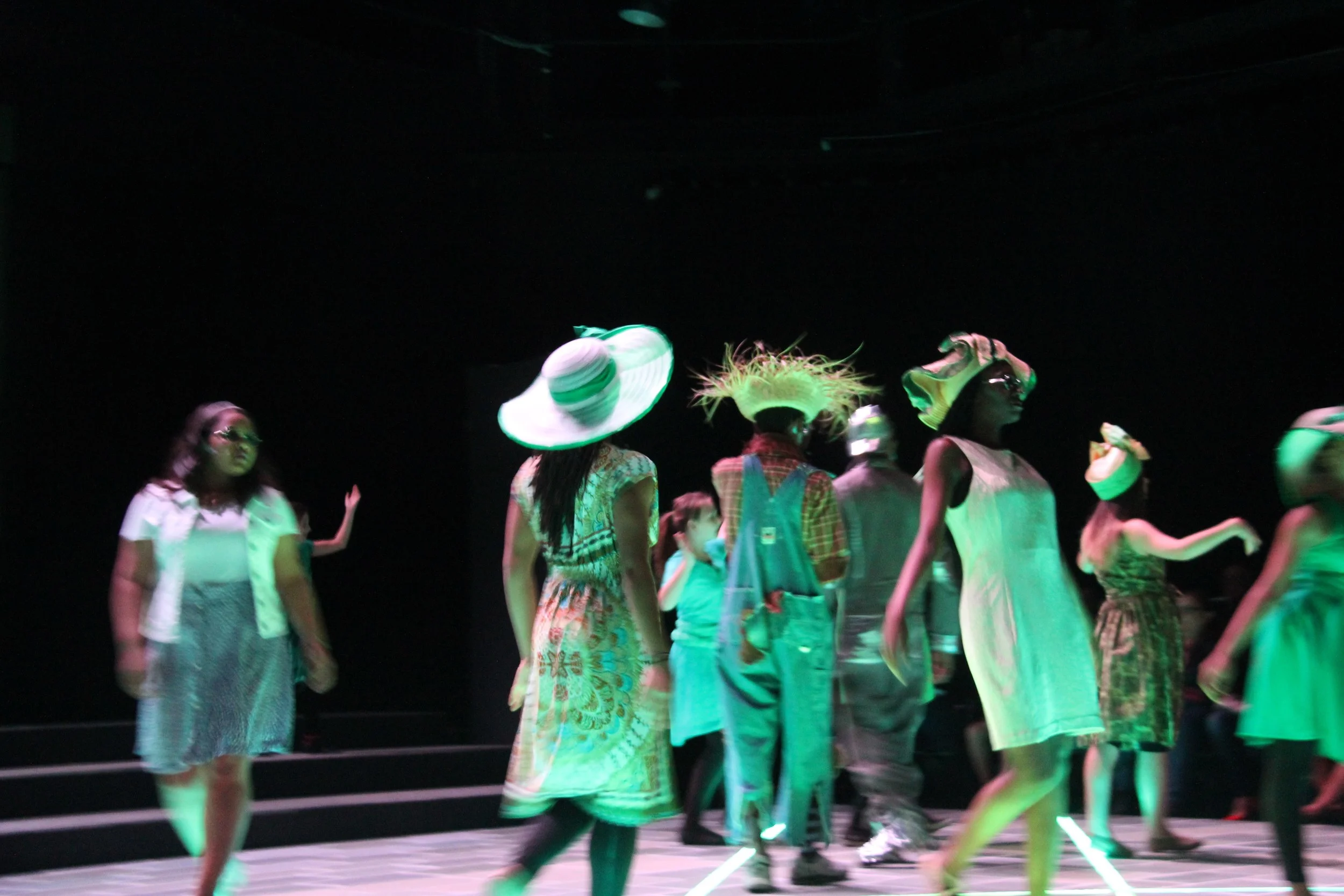Dorothy and friends walking through the Emerald City