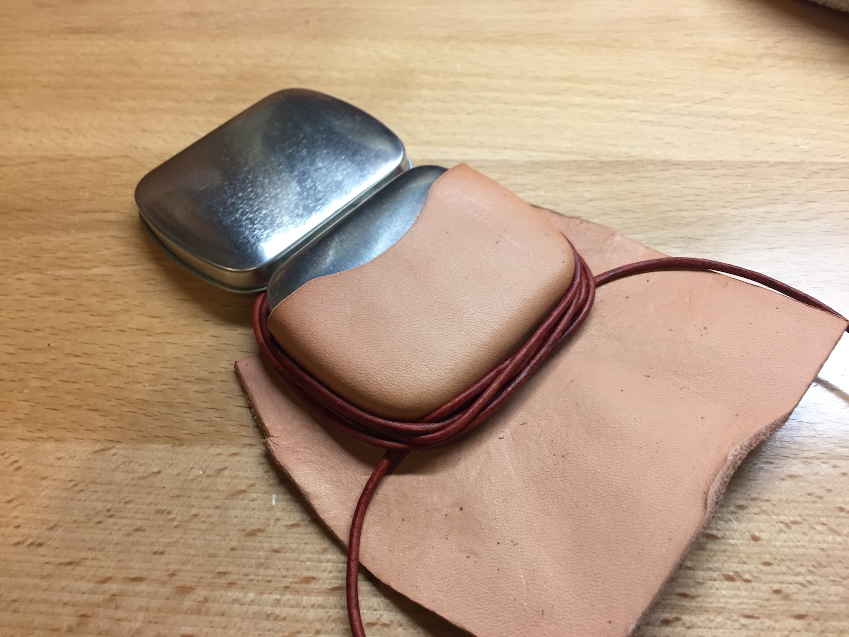 First I tried leather cord to keep the leather in place. Eh...