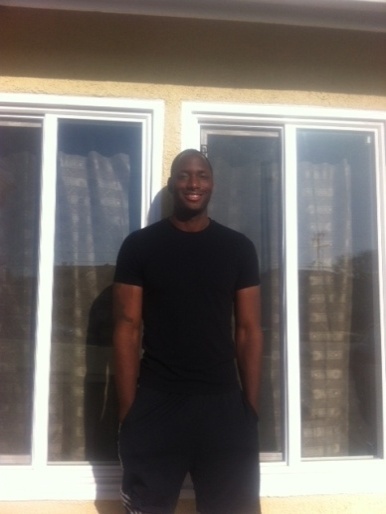 Curtis in front of his new home.
