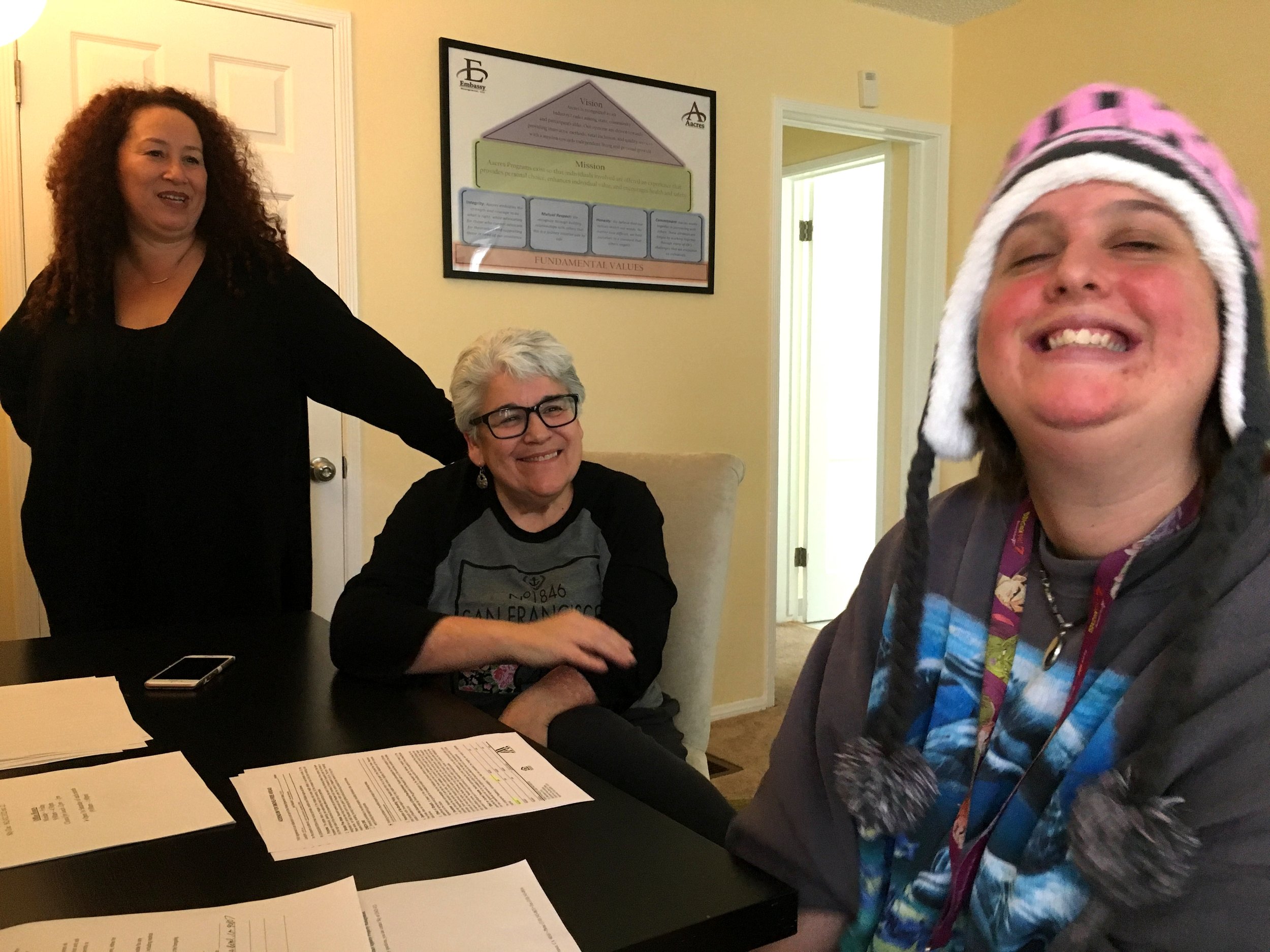 Marla (staff), Sindee (parent), and Julia (resident) signing paperwork on move-in day!