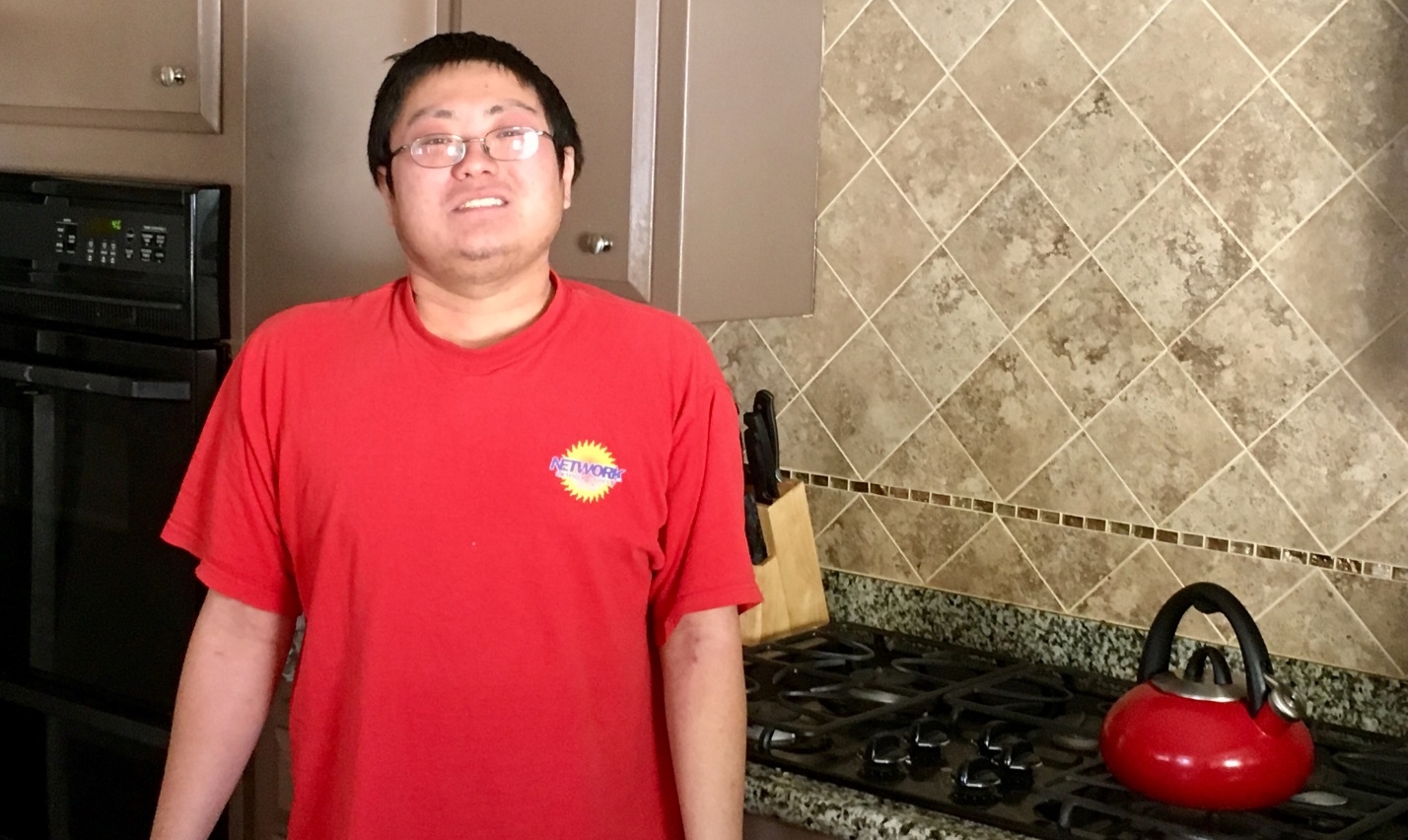 Justin standing in his HOPE home’s kitchen in Norwalk. He has come out of his shell in recent years to improve self-confidence and socialization skills. (HOPE)