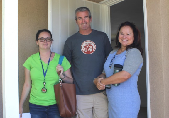 Emily smiles with parents as she prepares to move into her new HOPE home on Brink Ave.