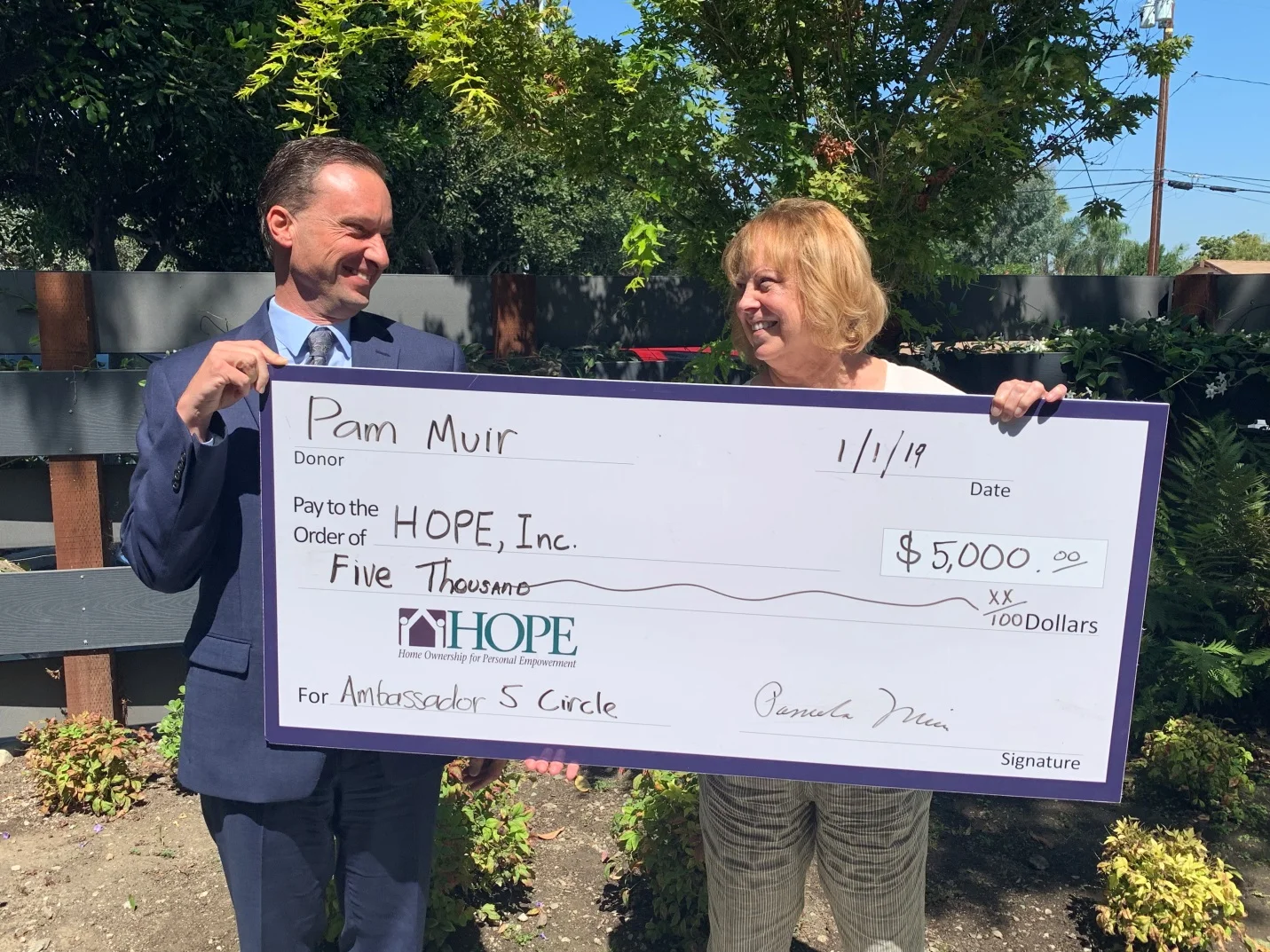 HOPE Executive Director Kristin Martin receives a generous $5,000 donation from Pam Muir as she officially joins the Ambassador 5 Circle. (HOPE)