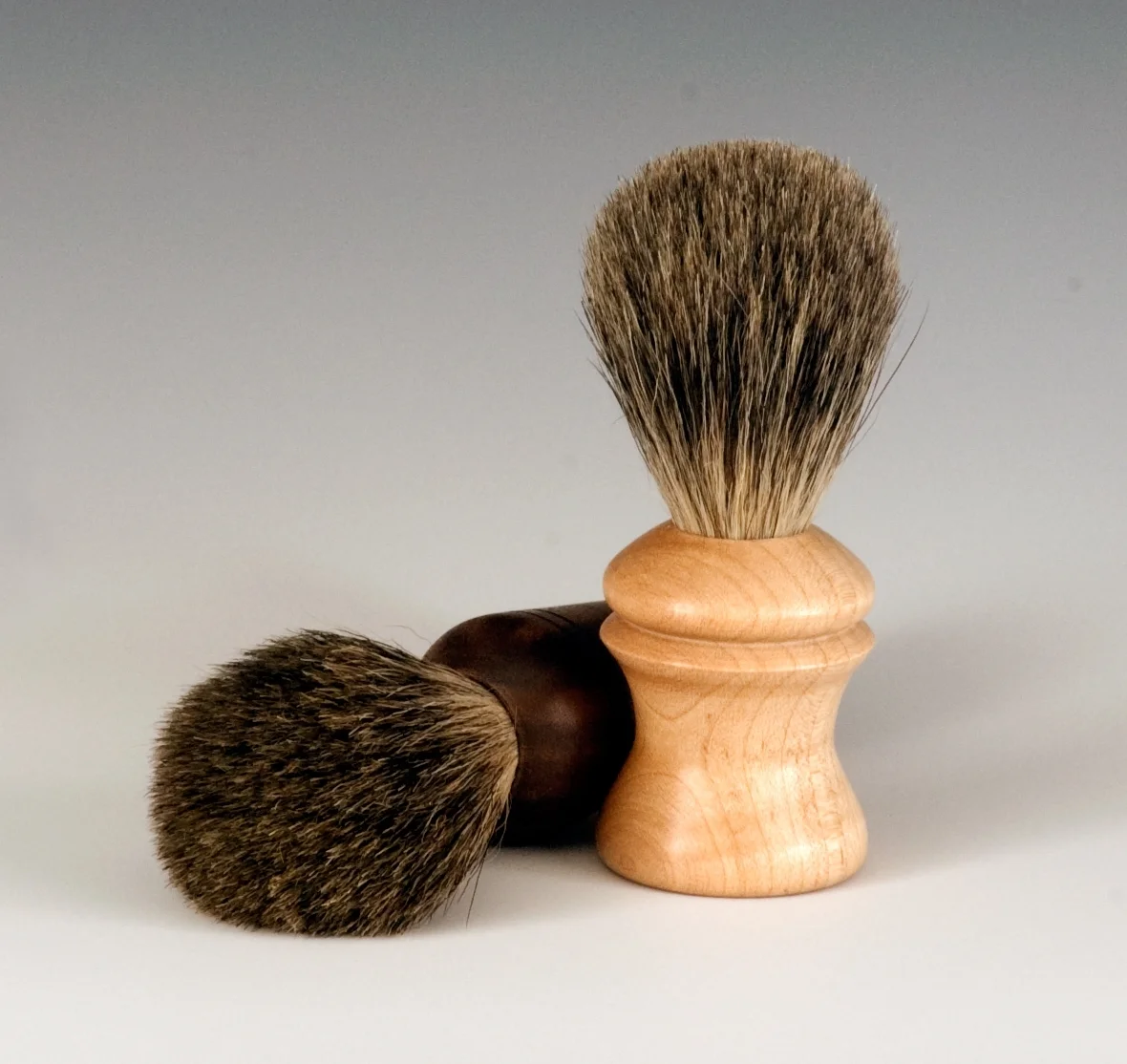   Shaving Brushes   These are shaving brushes made to show two domestic woods in the handles. The lighter one is Hard Maple and the darker is Black Walnut. The brush itself is Badger Hair, considered the top source for shaving brushes. These particul