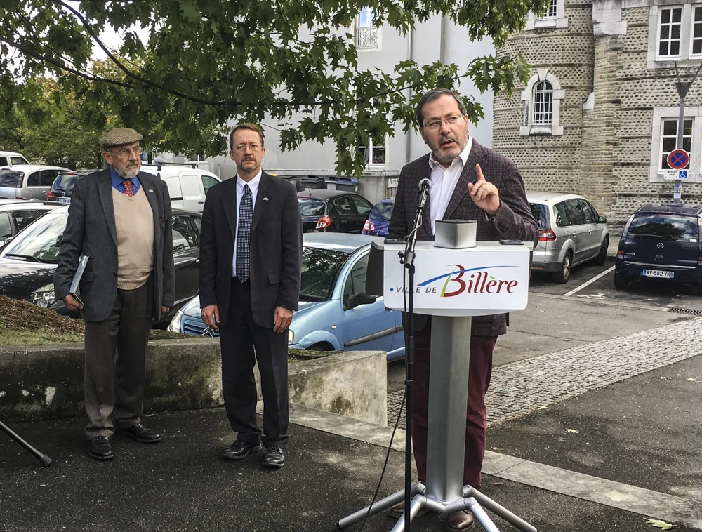 Jean-Yves Lalanne, mayor of Billère, introduces the planting ceremony while Bernard Dalisson, president of Les Pacaniers de Jefferson, and American Consul Daniel Hall await.