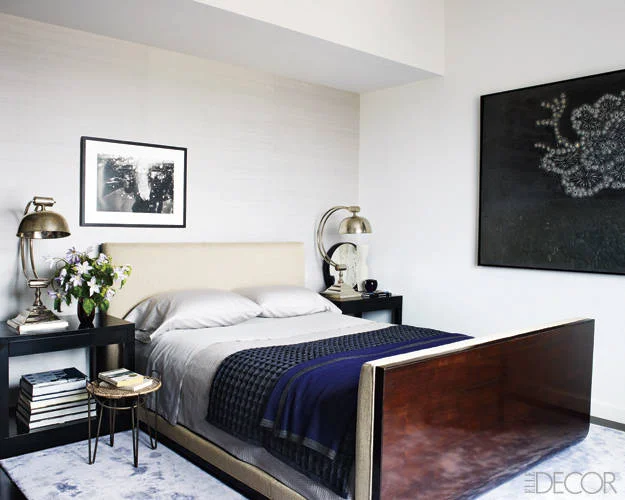 The wall of Hilary's bedroom is lined in a silk by MDC Wallcoverings. Bed, bedding, bedside tables & rug all by Calvin Klein Home.