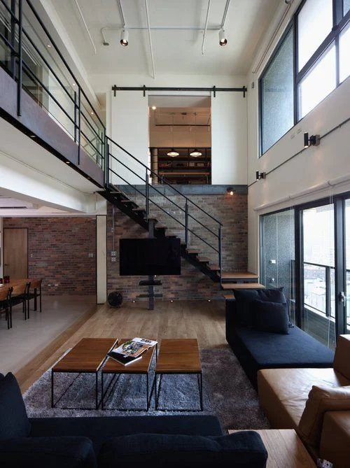 Love this Staircase and the three coffee tables.