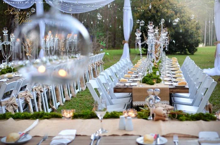 This Enchanted Chrystal Rainforest Wedding was styled and created by Sugar & Spice Events. I was lucky enough to work on this event and wow, it was absolute perfection! White Americano chairs, tables styled with hessian table runners, chrystal candelabras and moss, while over head the night sky was lit with fairy lights and hanging bulbs filled with tea light candles. Styled by Sugar & Spice Events.