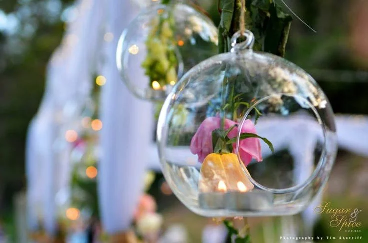 Hanging bulbs filled with tea light & upside-down roses. Styled by Sugar & Spice Events.