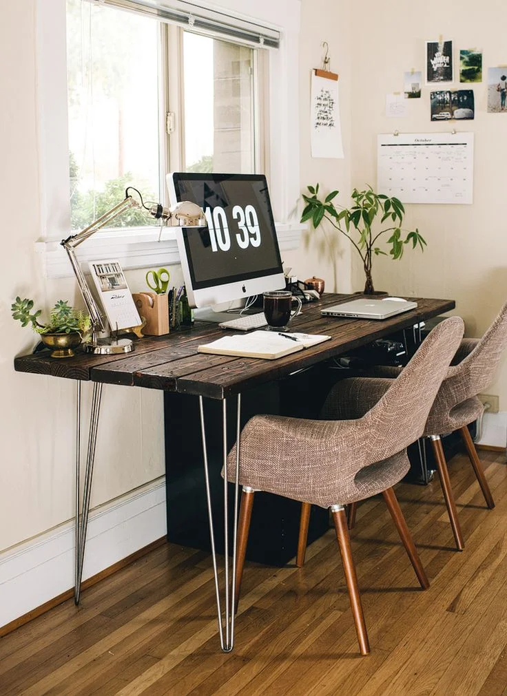 Raw timber, indoor plants, a calendar and images on the wall give this small space a beautiful easy feel.
