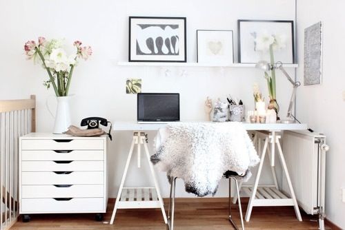 Tressle-leg desk, sheep skin over the chair, fresh blooms and some gorgeous art - I could sit in this space all day long!