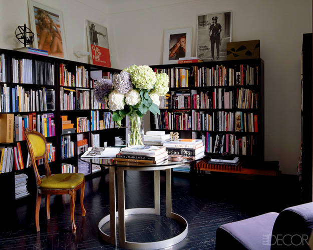 In the studio’s library, vintage posters and a Chris von Wangenheim photograph are propped on ebony bookcases, and the table is a 1970s Piero Pinto design.