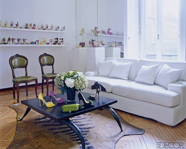 Atwood’s spring/summer 2009 designs for his own label are displayed on custom shelving and an ebony-and-horn table in the showroom; the zebra rug is vintage, and the fruitwood chairs are antique.