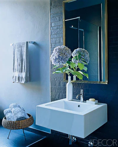 The walls and floor in the bath are paved in slate tile.