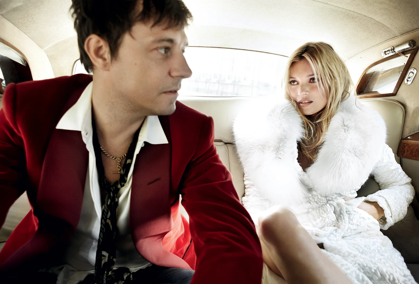 Jamie and Kate channel a modern-day Mick and Bianca Jagger, re-creating the couple’s 1971 backseat wedding portrait by royal photographer Lord Lichfield. Tom Ford velvet-and-fur coat. On Hince: Tom Ford red velvet jacket.
