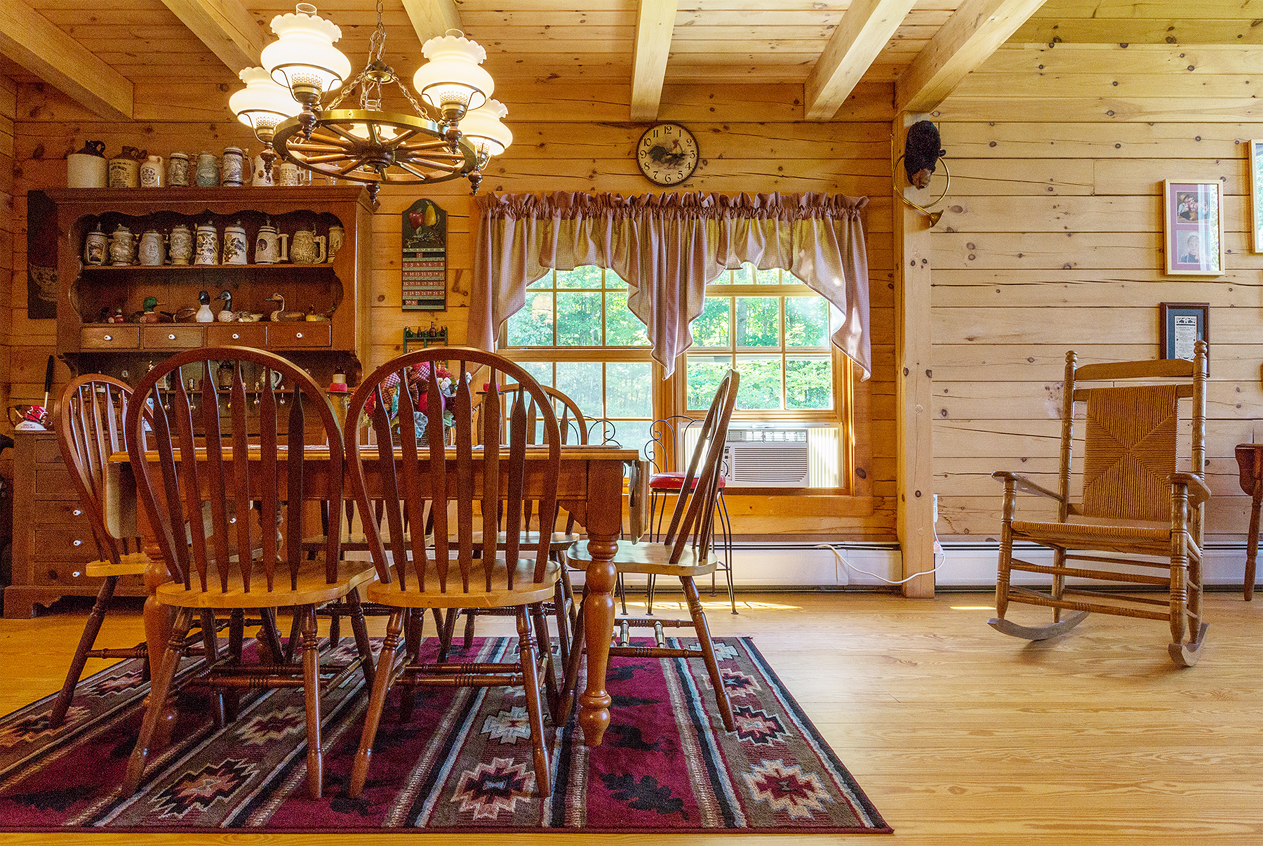  Inside of home. Table sits on top of the throw rug.  In front of this photo are two double windows.  