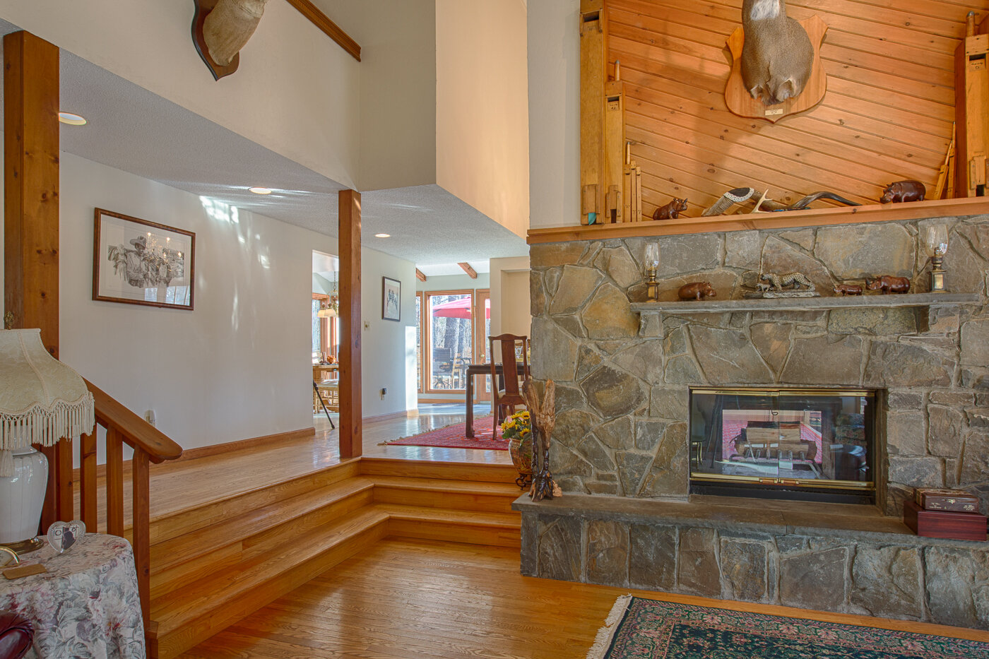  Inside home with picture of the sunken living room showing the stone fire place. 