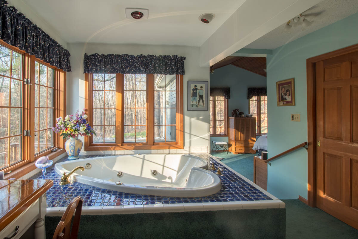  Hot tub in center of the room with plenty of windows outlining the outside wall.  