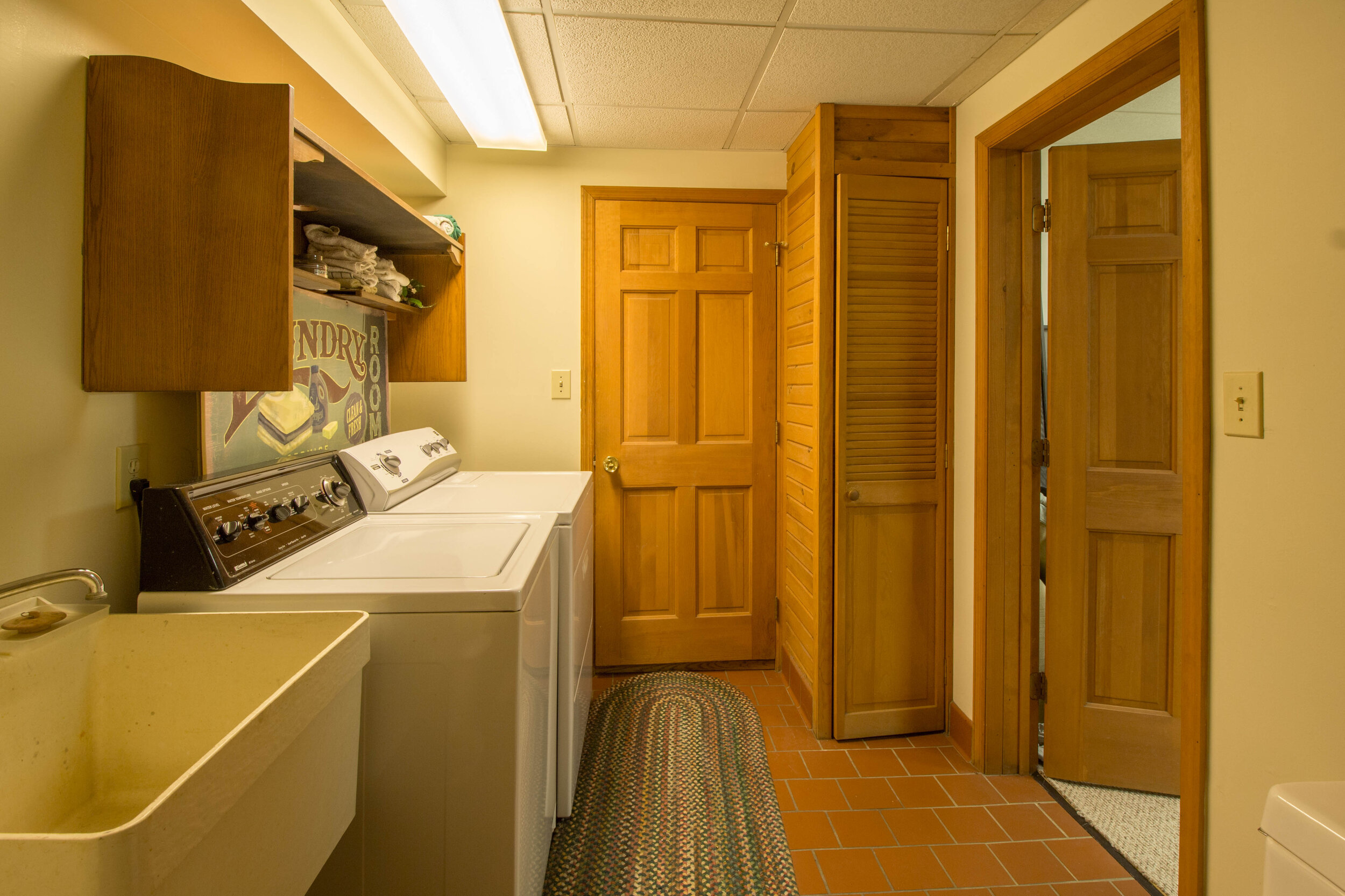  Laundry room with double sliding doors that open to it.  Washer and dryer are in this room along with a stand alone wash tub. 