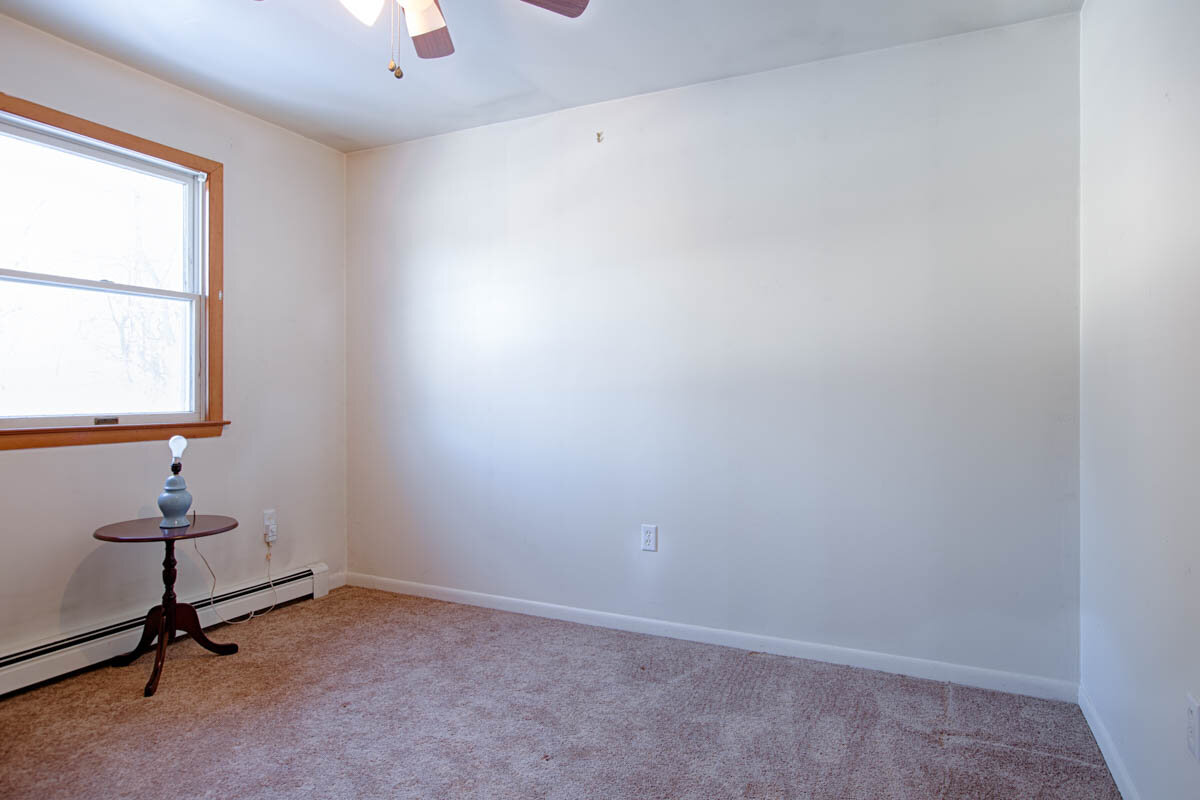  Another angle of living room.  There is a small circle table with a lamp on top to the left of the photo. 