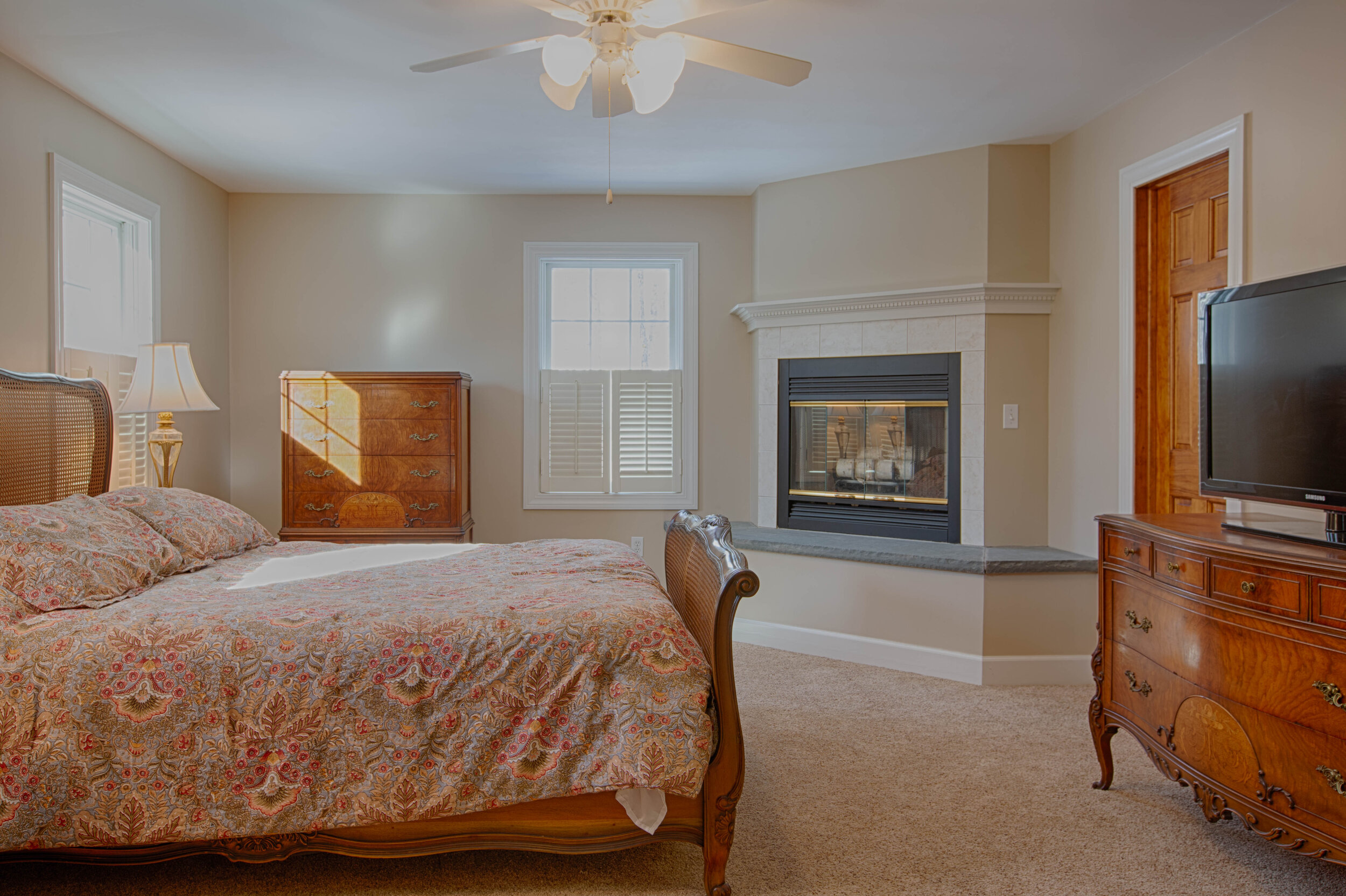  Master bedroom with sleigh bed in center.  There is a gas fireplace in the room too. 