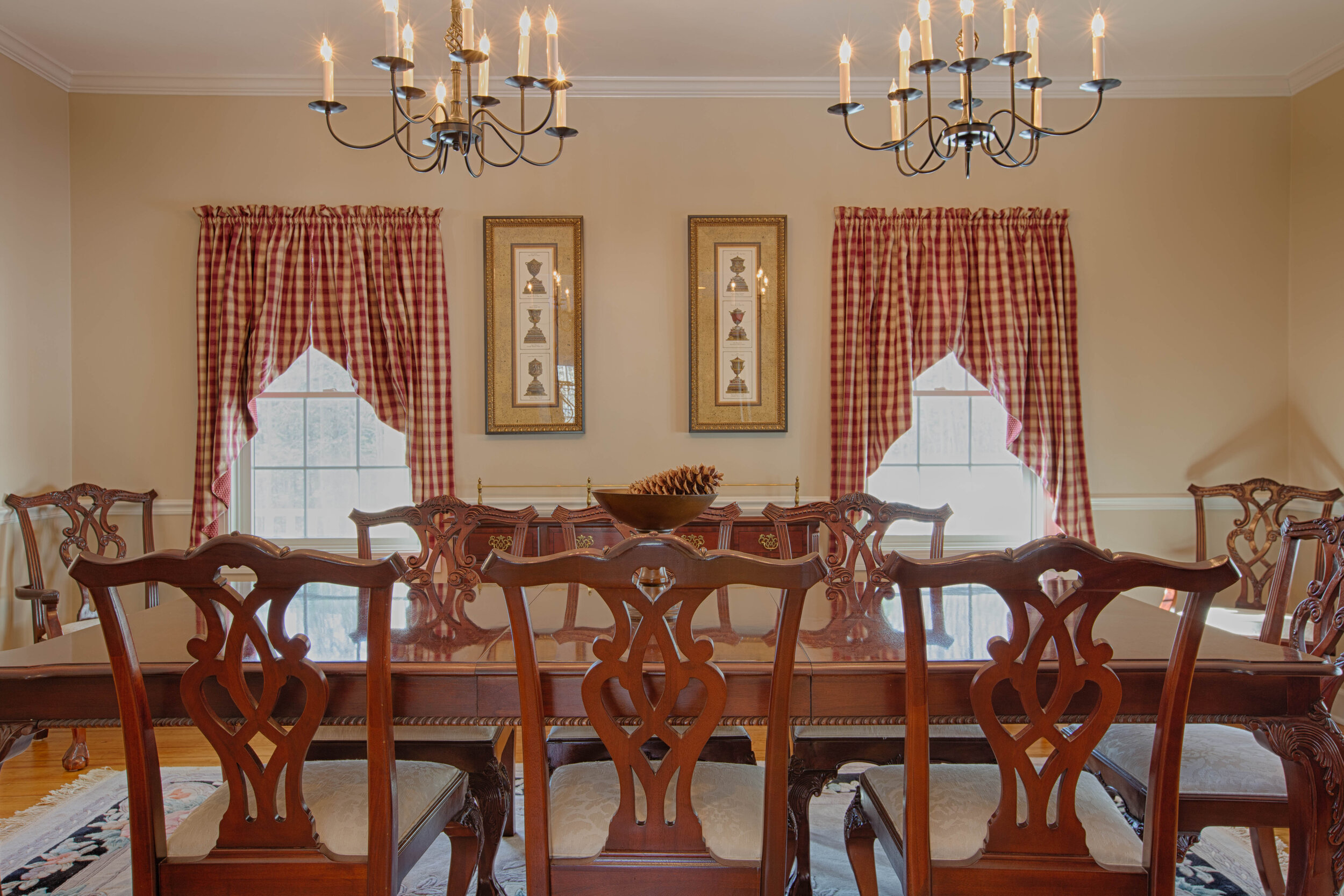  Dining room- focusing on the dining room table.  Window in the center of the wall with curtains hanging. 