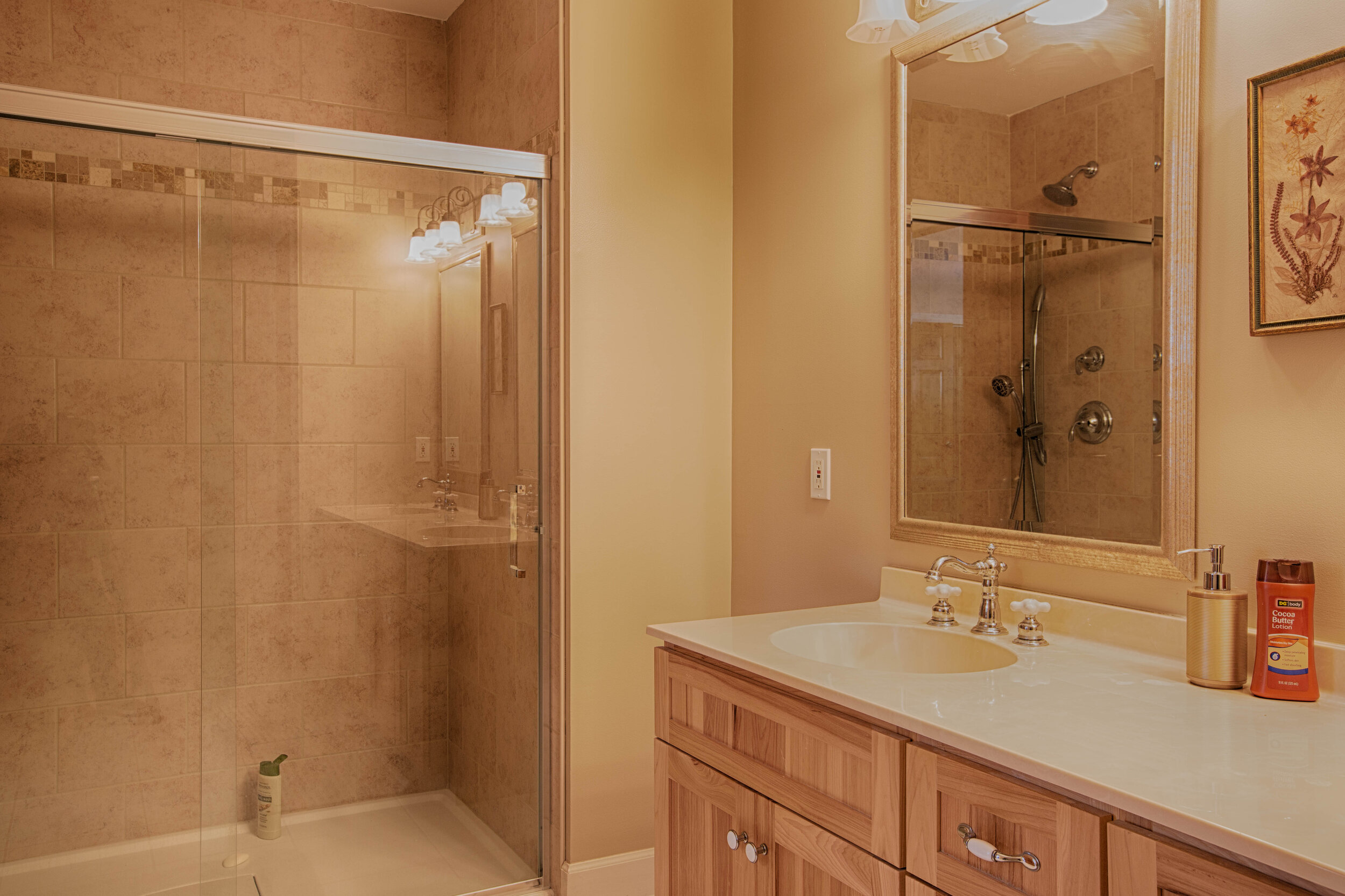  Bathroom with shower/tub combo, vanity with mirror above. 